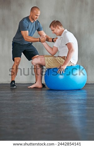 Physical therapy, balance and exercise ball with a man with a disability and physio consultation for rehabilitation. Physiotherapy, help and workout for health with helping and wellness for mobility