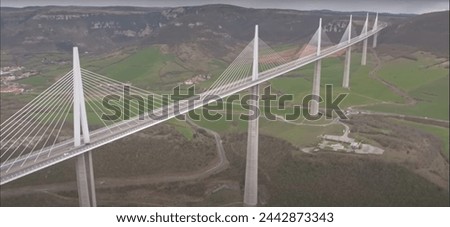 A bridge is a structure built to span a physical obstacle (such as a body of water, valley, road, or railway) without blocking the way underneath. It is constructed for the purpose of providing passag Royalty-Free Stock Photo #2442873343
