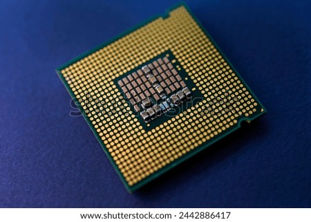 A computer processor on a blue background. Contacts on the processor case.