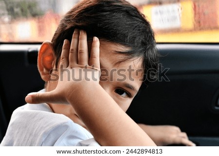Childhood fear. boy covers his face with his hands. Royalty-Free Stock Photo #2442894813