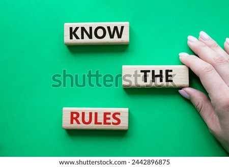 Know the rules symbol. Wooden blocks with words Know the rules. Beautiful green background. Businessman hand. Business and Know the rules concept. Copy space.