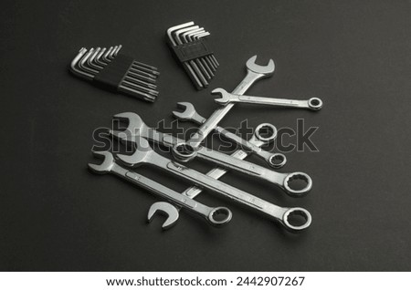 wrench tools and Allen keys, a set of chrome-plated metal tools, on a dark background, black background, for DIY, repairing, for a handyman, mechanic or as a gift for a man