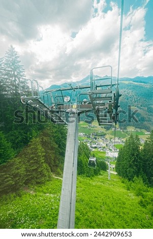 Cable Car Cable Support System on a mountain forst in a Swizerland on a cloudy summer day Royalty-Free Stock Photo #2442909653