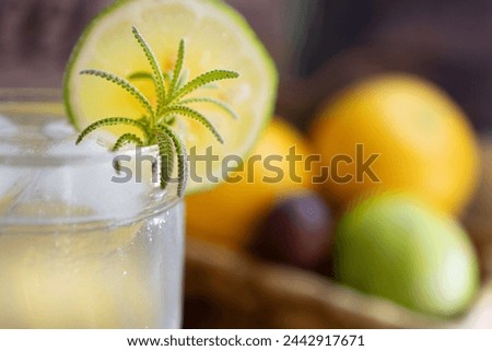 Close up picture of refreshing lemonade drink for a hot summer day. Out of focus background of fresh fruit. 