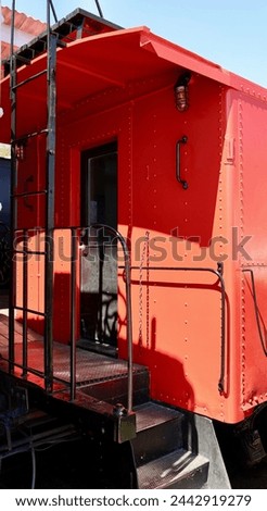 Bright red antique train caboose at the station Royalty-Free Stock Photo #2442919279