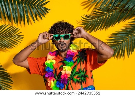 Photo of impressed man dressed print shirt flower necklace touch sunglass on beach staring at sale isolated on yellow color background