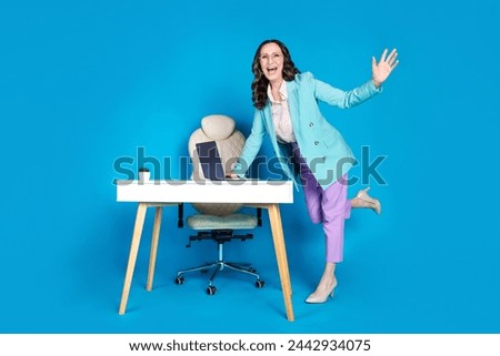Full length photo of cheerful excited woman wear blazer enjoying working office modern device isolated blue color background