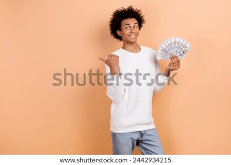 Photo of positive satisfied man win lottery jackpot recommend casino club empty space promo isolated on beige color background