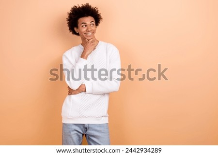 Photo of positive thoughtful man dressed white trendy clothes look interesting news empty space isolated on beige color background