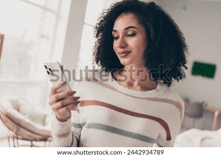 Photo of shiny good mood lady dressed striped pullover communicating modern device indoors apartment room