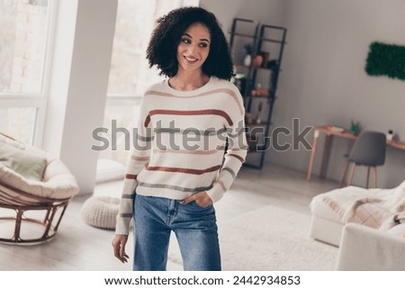 Photo of dreamy adorable lady dressed striped pullover choosing new home indoors apartment room Royalty-Free Stock Photo #2442934853