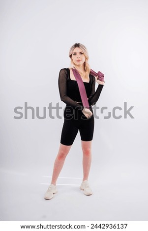Photo of woman workout with resistance band. Strength and motivation.