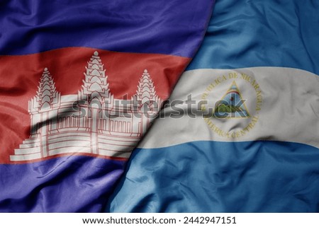 big waving national colorful flag of nicaragua and national flag of cambodia. macro