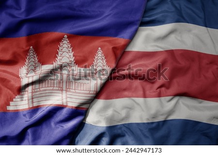 big waving national colorful flag of costa rica and national flag of cambodia. macro