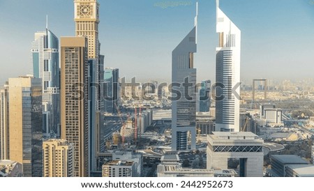 Skyline view of the buildings of Sheikh Zayed Road and DIFC timelapse in Dubai, UAE. Skyscrapers and twin towers in financial center aerial view from above before sunset