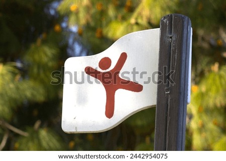 white flag with red stick figure at children's playground