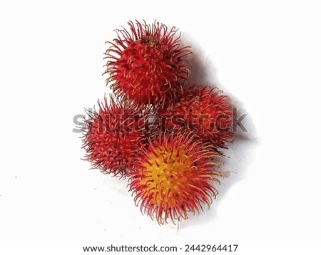 A tropical fruit called rambutan (Nephelium lappaceumon) that is fresh and ripe is red in color and sweet on a white background