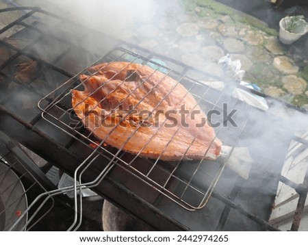 white snapper grilled over hot coals with spices that have been smeared