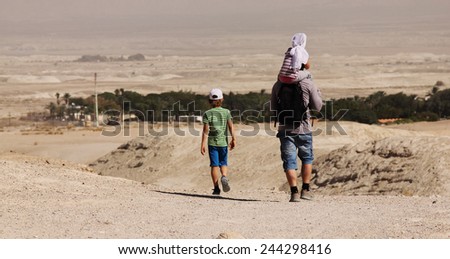 father with two children outdoors
