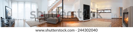 Panoramic view of modern interior with living room and kitchen Royalty-Free Stock Photo #244302040