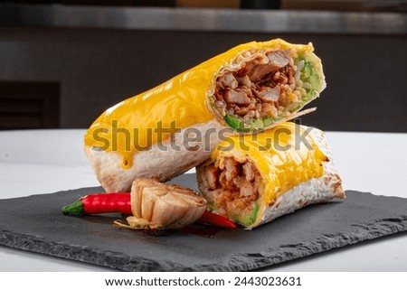 Burrito with cheese and meat cut on a plate