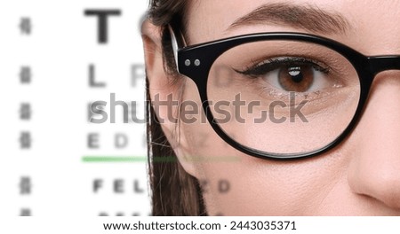 Vision test. Woman in glasses and eye chart on white background, closeup. Banner design