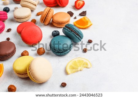Colorful french dessert macarons with fresh fruits and nuts.