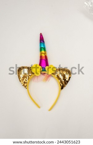A yellow unicorn children's headband on the table