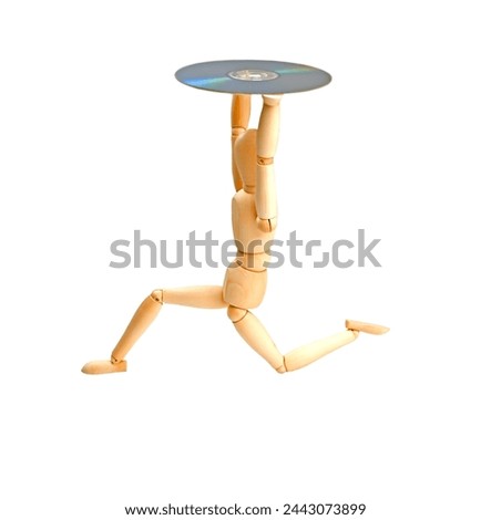 wood mannequin with CD-rom on white background Royalty-Free Stock Photo #2443073899