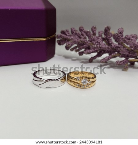 Wedding rings. Detail of wedding rings on the wedding day. Macro photo of the product with purple ringbox and lavender background