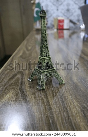 Eiffel tower famous monument of Paris France in golden bronze color isolated in office desk. Metal Eiffel Tower Paris