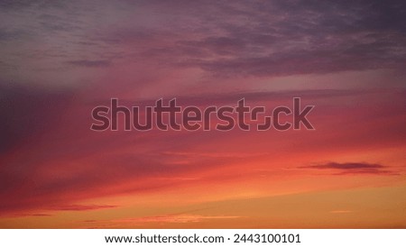 An abstract background of red-orange clouds in the dark evening sky, abstract timelapse