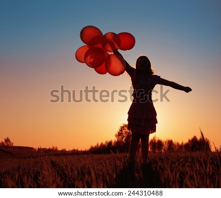 girl with orange balloons outdoor