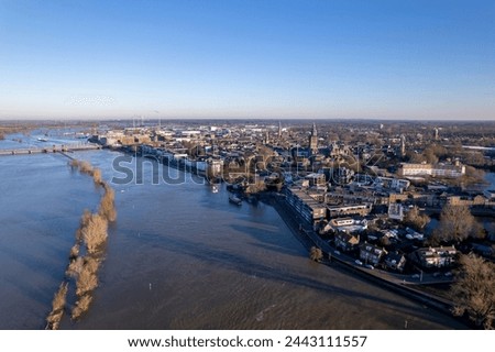 Aerial of river IJssel passing Dutch tower town Zutphen, The Netherlands Royalty-Free Stock Photo #2443111557