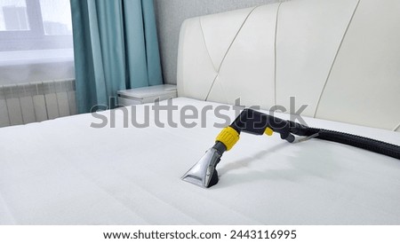 Spring cleaning or regular cleaning of the mattress. Dry cleaning of the mattress at home. Royalty-Free Stock Photo #2443116995