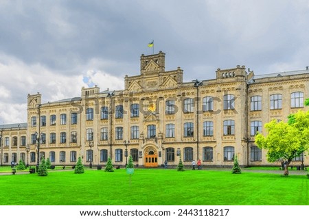 It's photo of green lawn in front of main building of National Technical University of Ukraine. Its view of Igor Sikorsky Kyiv Polytechnic Institute. It's the sunny day with cloudy sky