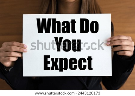 What do you expect? Woman with white page, black letters. Requirements, experience, job interview. Royalty-Free Stock Photo #2443120173
