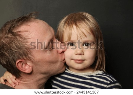 Family, fatherhood and people concept. Happy affectionate father kissing little baby daughter Royalty-Free Stock Photo #2443141387