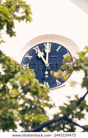 big black clock dial on a tower
