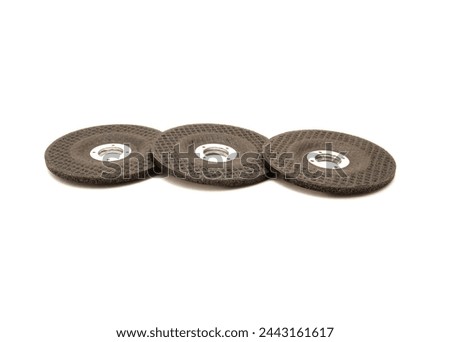 Three aluminum oxide general purpose griding wheels, manufactured with heat treated grit grains in high concentrations smooth when cutting steel and ferrous metals, stone, isolated background. White Royalty-Free Stock Photo #2443161617