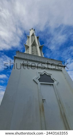 the mosque's minaret towers high into the sky Royalty-Free Stock Photo #2443163355