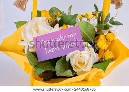 You Make My Heart Smile text on a business card in a basket with blooming flowers