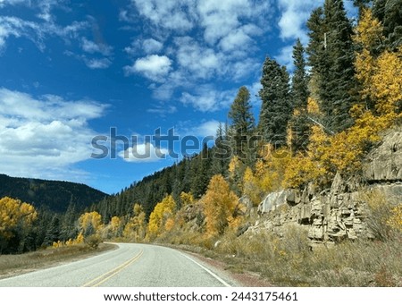 High Road to Taos Scenic Byway in New Mexico near Apache Canyon. Beautiful autumn colors, rugged terrain of the Sangre de Cristo Mountains, Carson National Forest. New Mexico highway 518. Royalty-Free Stock Photo #2443175461
