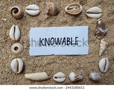 Knowable writting on beach sand background.