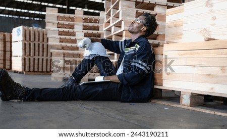Multiracial engineer, worker sitting resting on floor feel tired from overworked in factory. Young adult technician feel weak, stress, exhausted, worried, frustrated, unhappy, hopeless, or headache Royalty-Free Stock Photo #2443190211