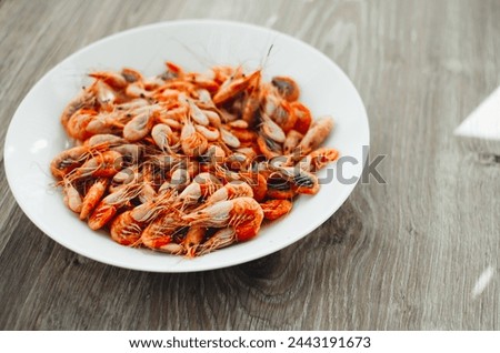 Azov shrimps boiled on a plate daylight from the window
