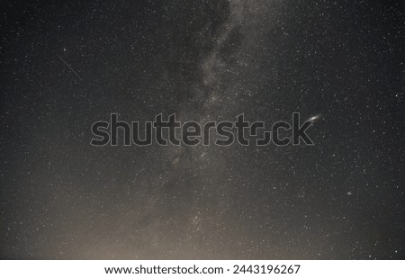 View of the Perseids, the Milky Way and the Andromeda galaxy. A gentle gradient in the graphite shades of the night sky.