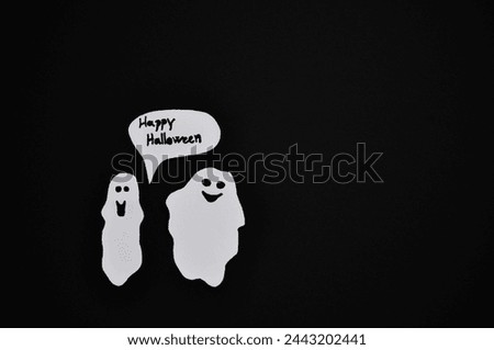 white ghosts on a black background - happy halloween