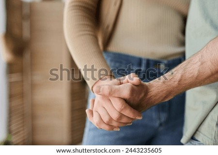 Cropped view closeup image of couple in love holding hands. Symbol sign sincere feelings, compassion
