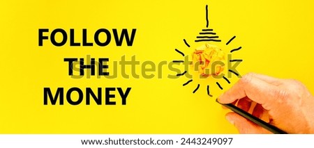 Follow the money symbol. Concept words Follow the money on beautiful yellow paper. Beautiful yellow background. Light bulb icon. Businessman hand. Business and follow the money concept. Copy space.